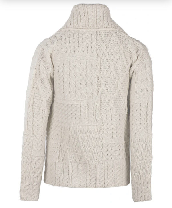 A white sweater with a large pattern on it.