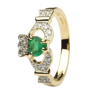 A gold ring with an emerald and diamond claddagh.