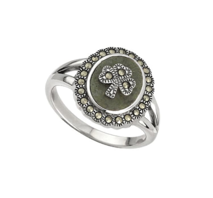 A silver ring with a green stone and marcasite.