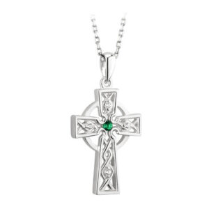 A cross with a green stone on it.