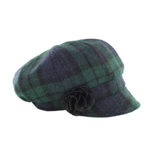 A green and black plaid hat with a flower on the side.