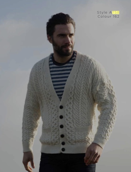 A man in a white sweater and striped shirt.