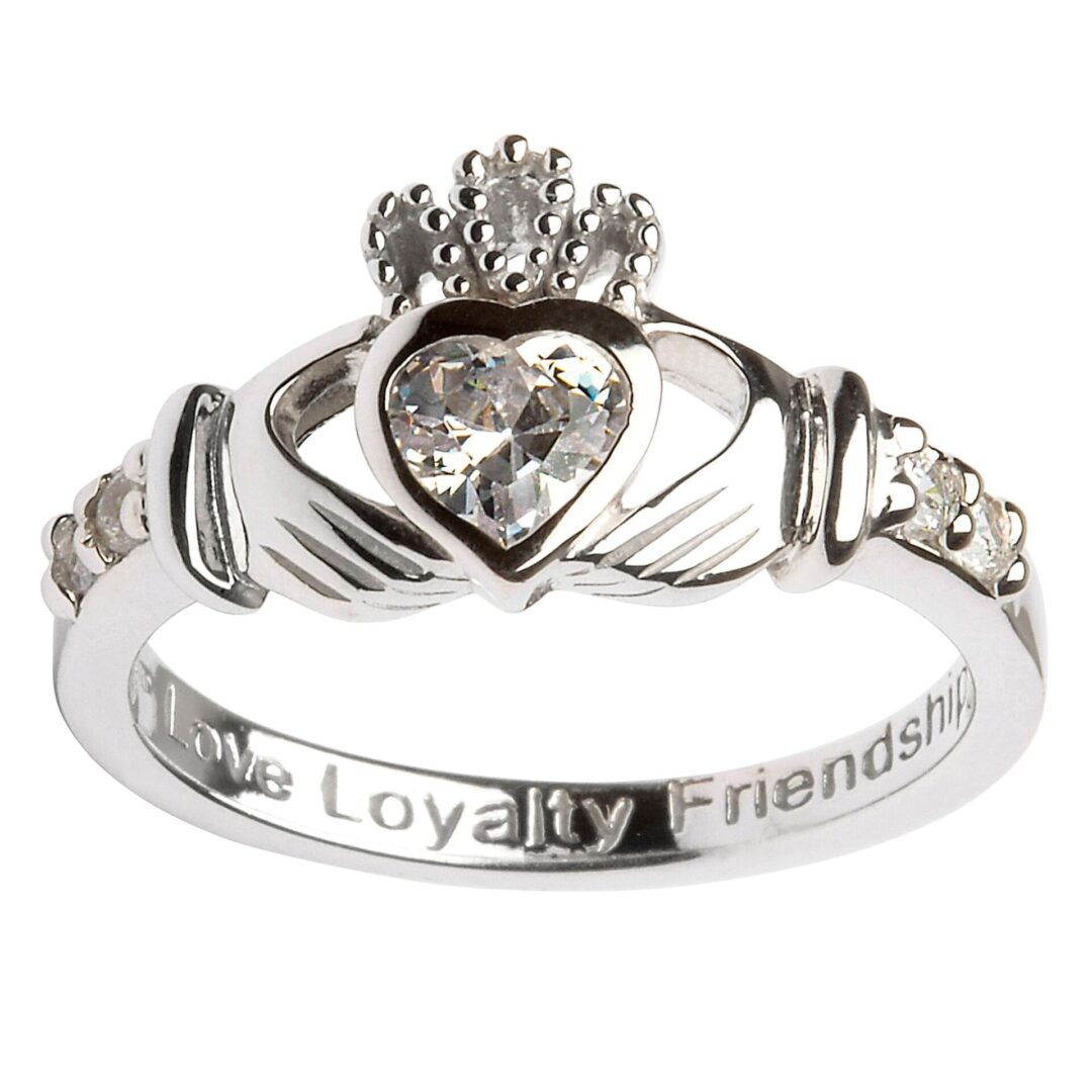 A claddagh ring with the words " loyalty friendship " engraved on it.