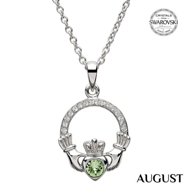 A silver claddagh necklace with green stone.