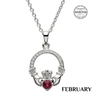 A claddagh necklace with a heart shaped stone.