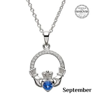 A claddagh necklace with a blue heart shaped stone.