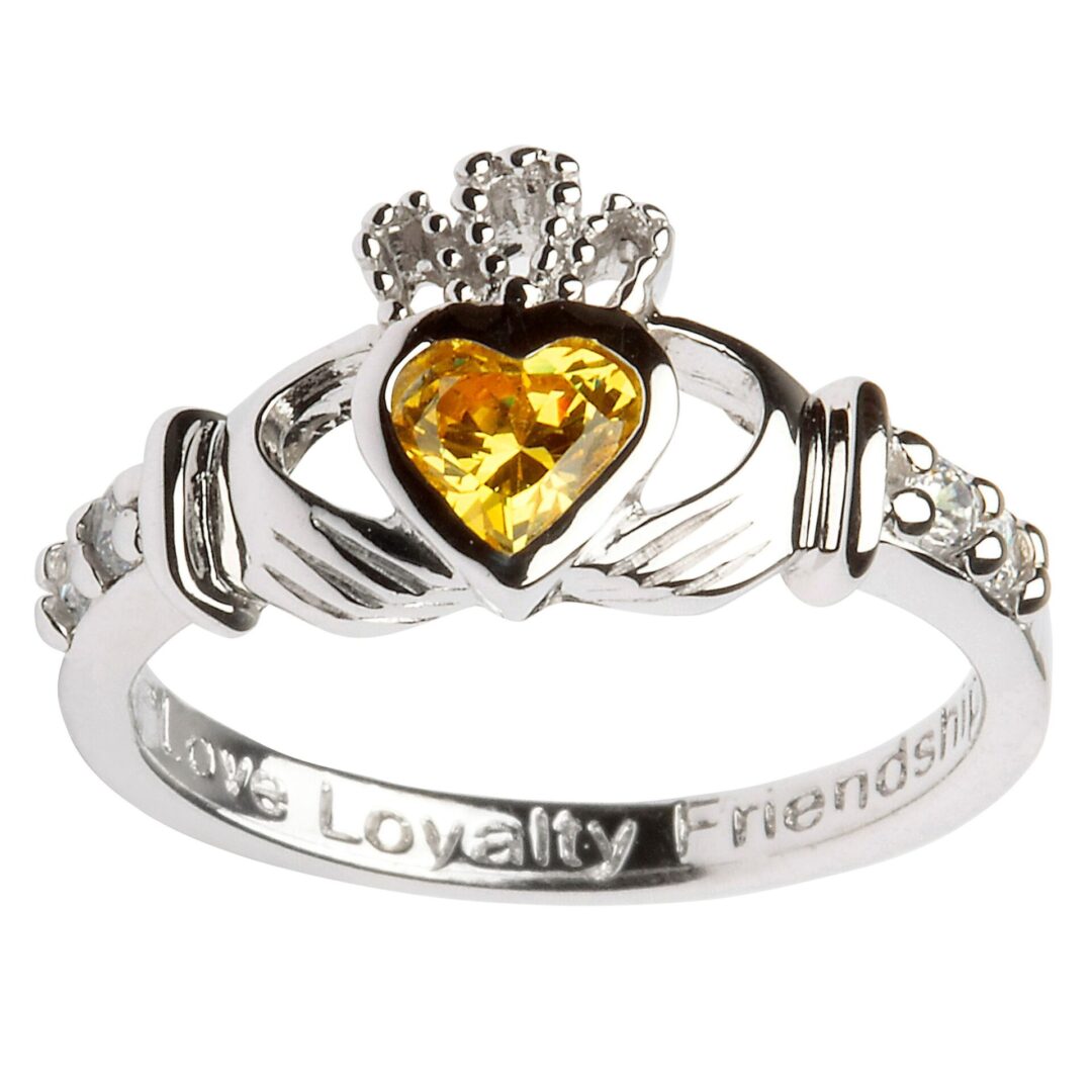 A claddagh ring with the words " loyalty, friendship ," and citrine heart.
