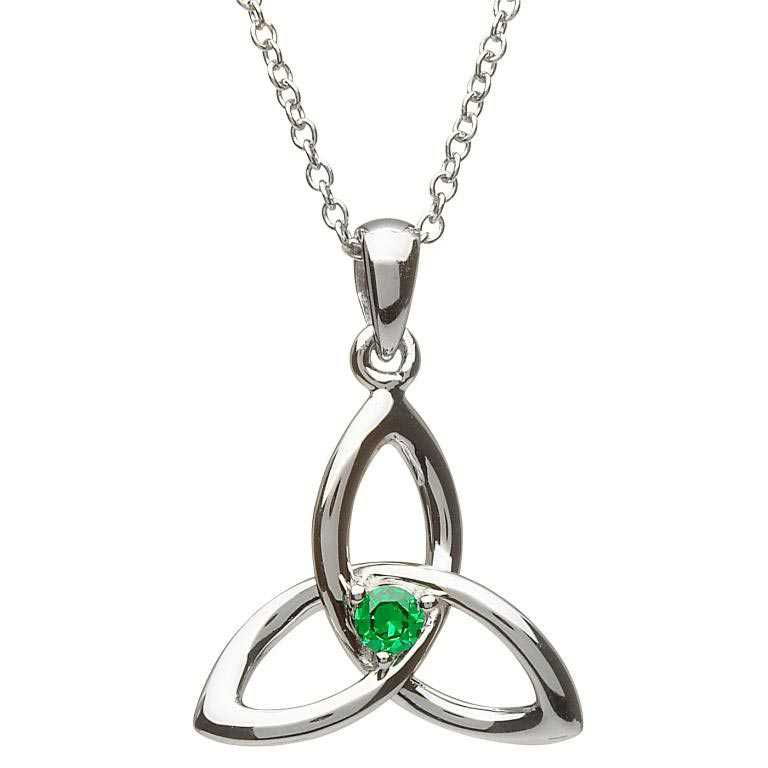 A silver necklace with a green stone on it