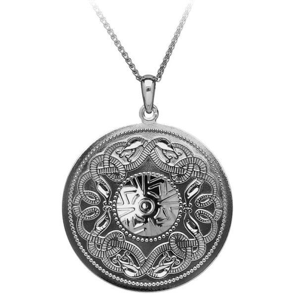 A silver necklace with a round medallion.