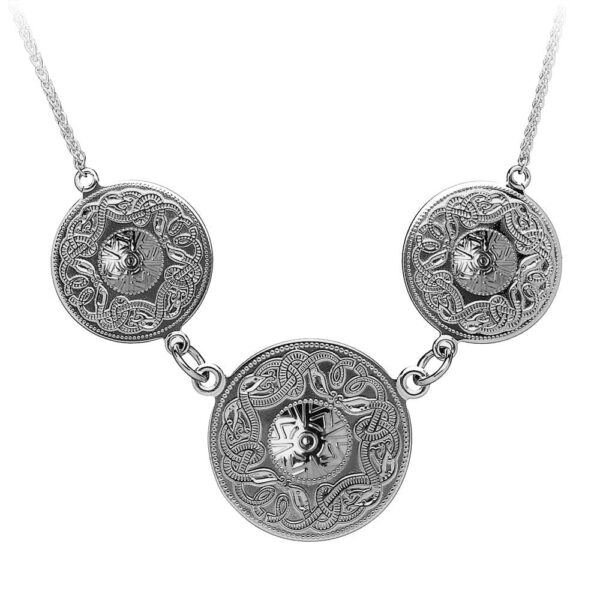 A silver necklace with three circles on it.