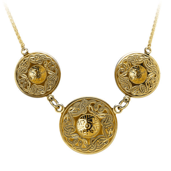 A gold necklace with three circles on it.