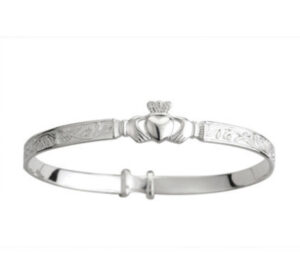 A silver claddagh bracelet with the irish symbols engraved on it.