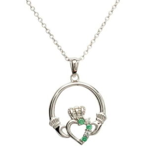 A silver necklace with a claddagh pendant and green stones.