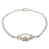 A silver bracelet with a claddagh and gold heart.