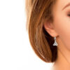 A woman with long hair wearing earrings.