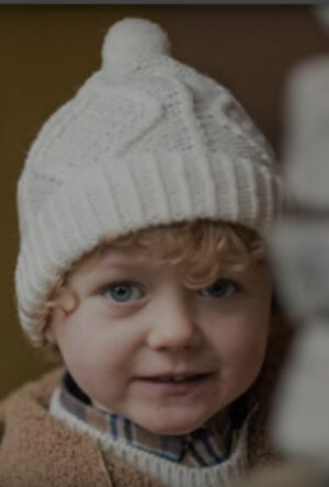 A child wearing a white hat and jacket.