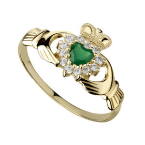 A gold claddagh ring with green heart shaped stone.