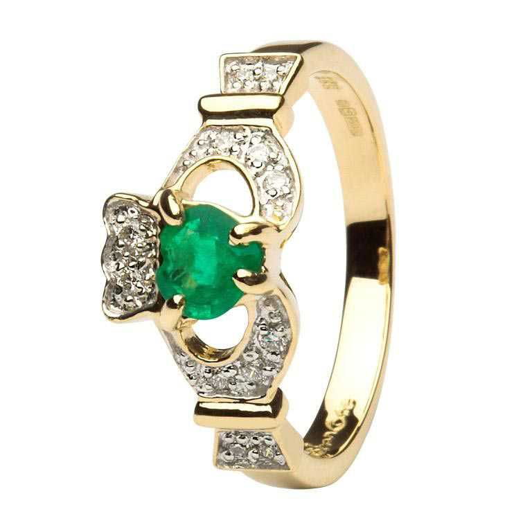 A gold ring with an emerald and diamond claddagh.