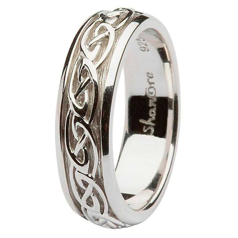 A silver ring with a celtic design on it.