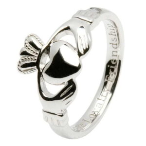 A claddagh ring with the irish words for love and loyalty engraved on it.