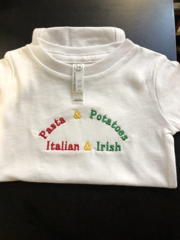 A white shirt with the words pasta and potatoes, italian and irish on it.