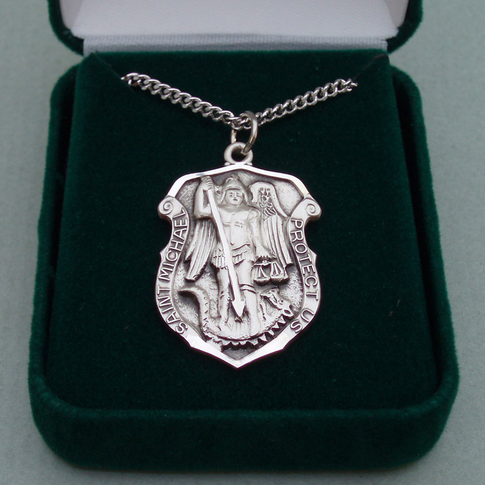 A silver medal in the shape of a police badge.