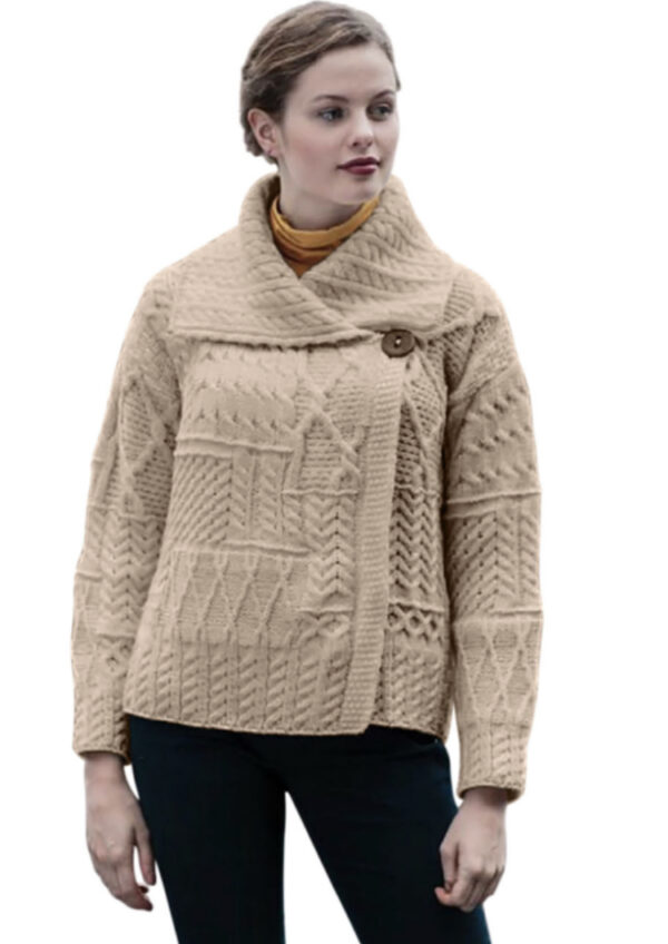 A woman wearing a beige sweater with buttons.