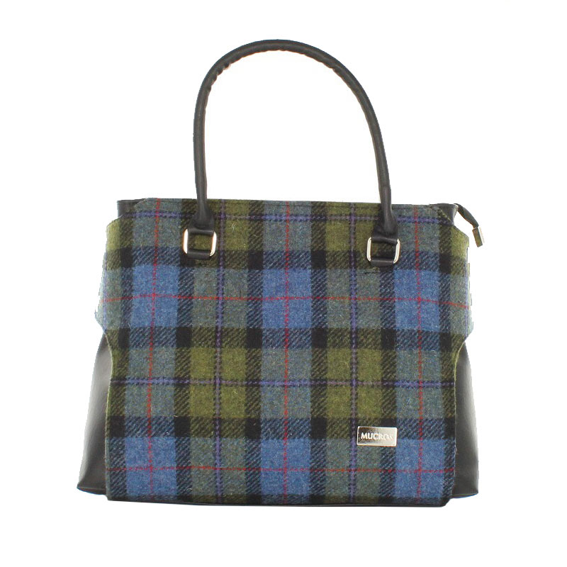 A blue and green plaid bag with leather handles.