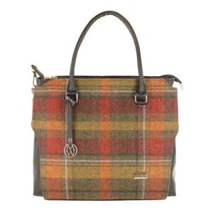 A plaid bag with a leather handle and strap.