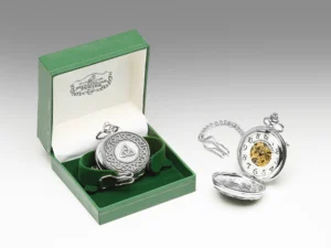 A silver pocket watch sitting in its box next to another one.
