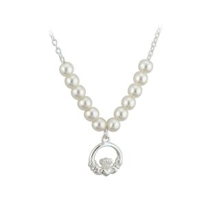 A white pearl necklace with a silver claddagh pendant.