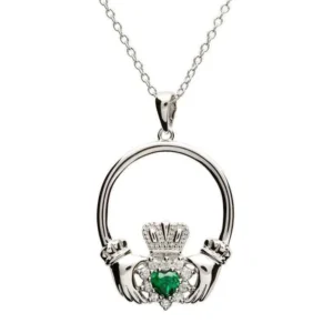A silver claddagh necklace with green stone.