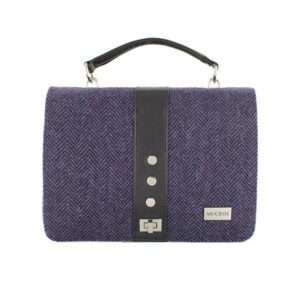 A purple bag with black leather and silver buttons.