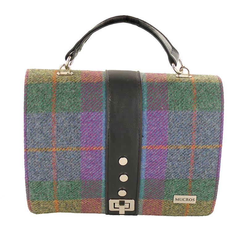 A bag that is very colorful and has some leather straps.