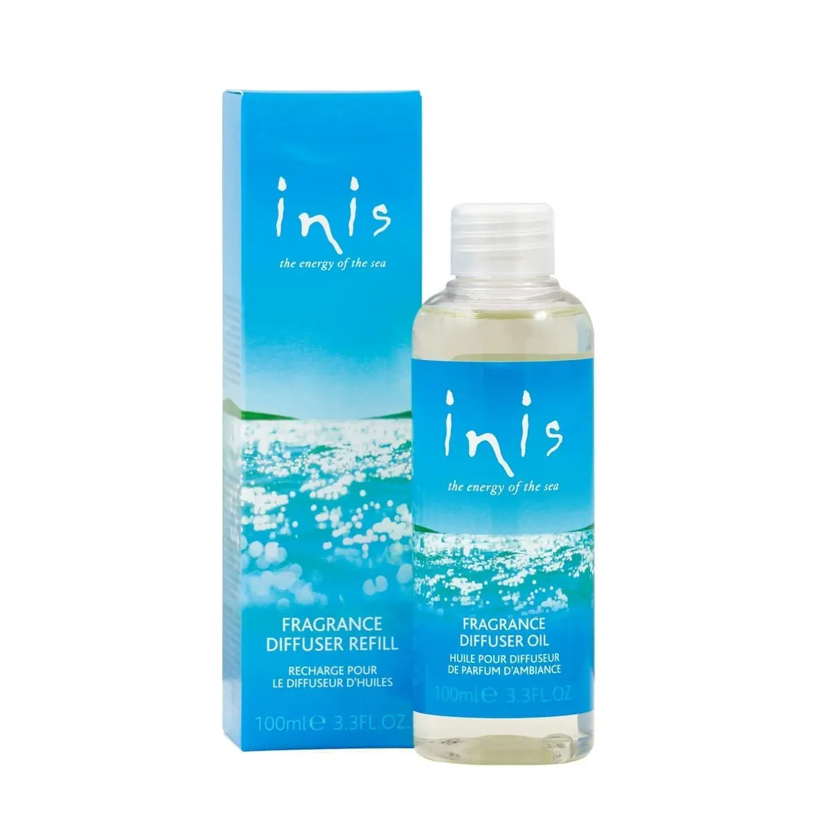 A bottle of inis oil sitting next to its box.