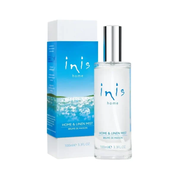 A bottle of inis perfume sitting next to its box.