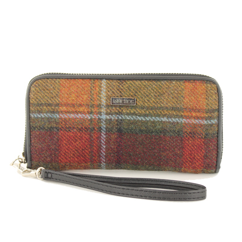 A brown and red plaid wallet with a black strap.