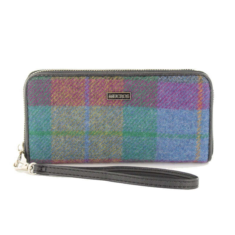 A multi colored plaid wallet with a wrist strap.