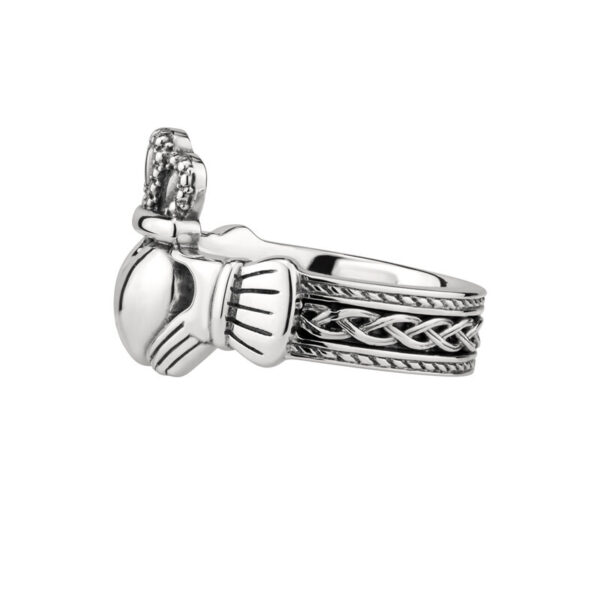 A silver claddagh ring with a celtic knot design.