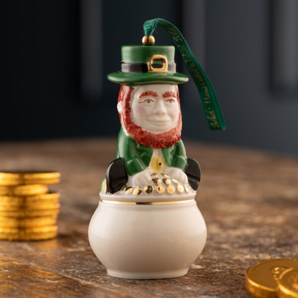 A leprechaun ornament sitting on top of a pot.
