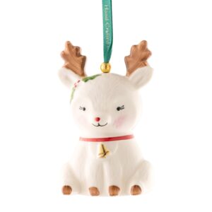 A white reindeer ornament with bells hanging from it's ears.