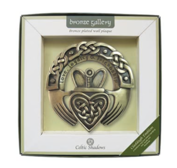 A box with a claddagh ornament in it