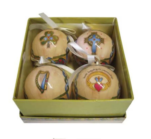 A box of four ornaments with different designs.