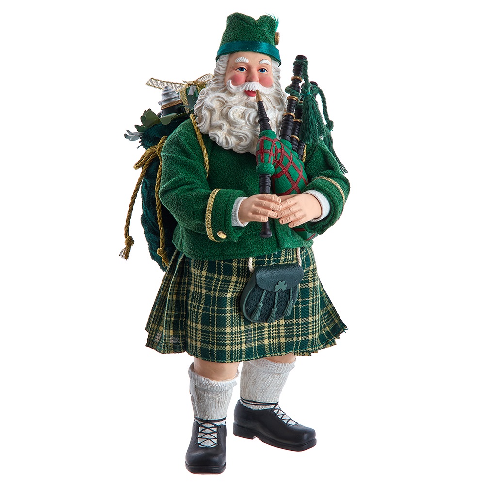 A man in green kilt and hat standing next to bagpipes.
