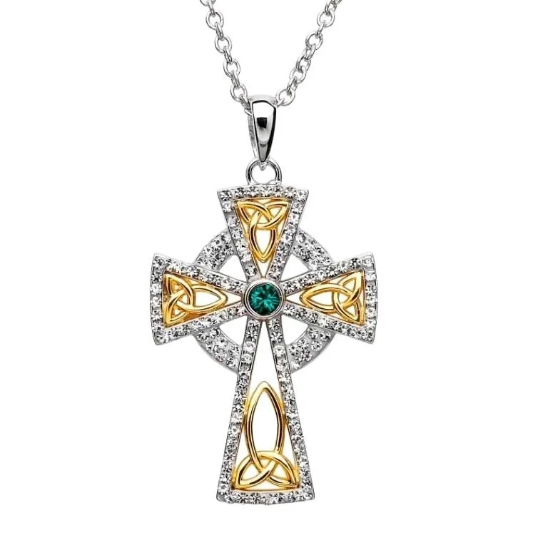 A cross with gold and white stones on it