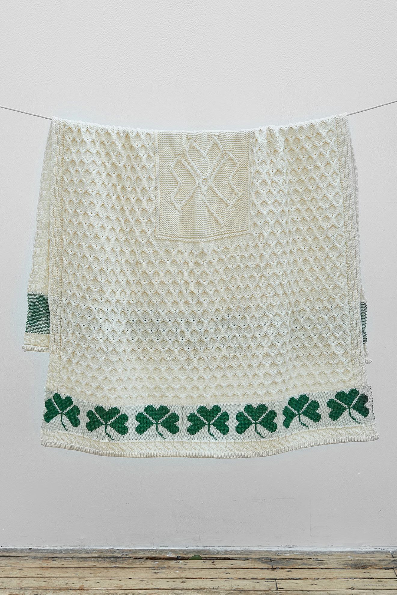 A white towel with green shamrocks on it.