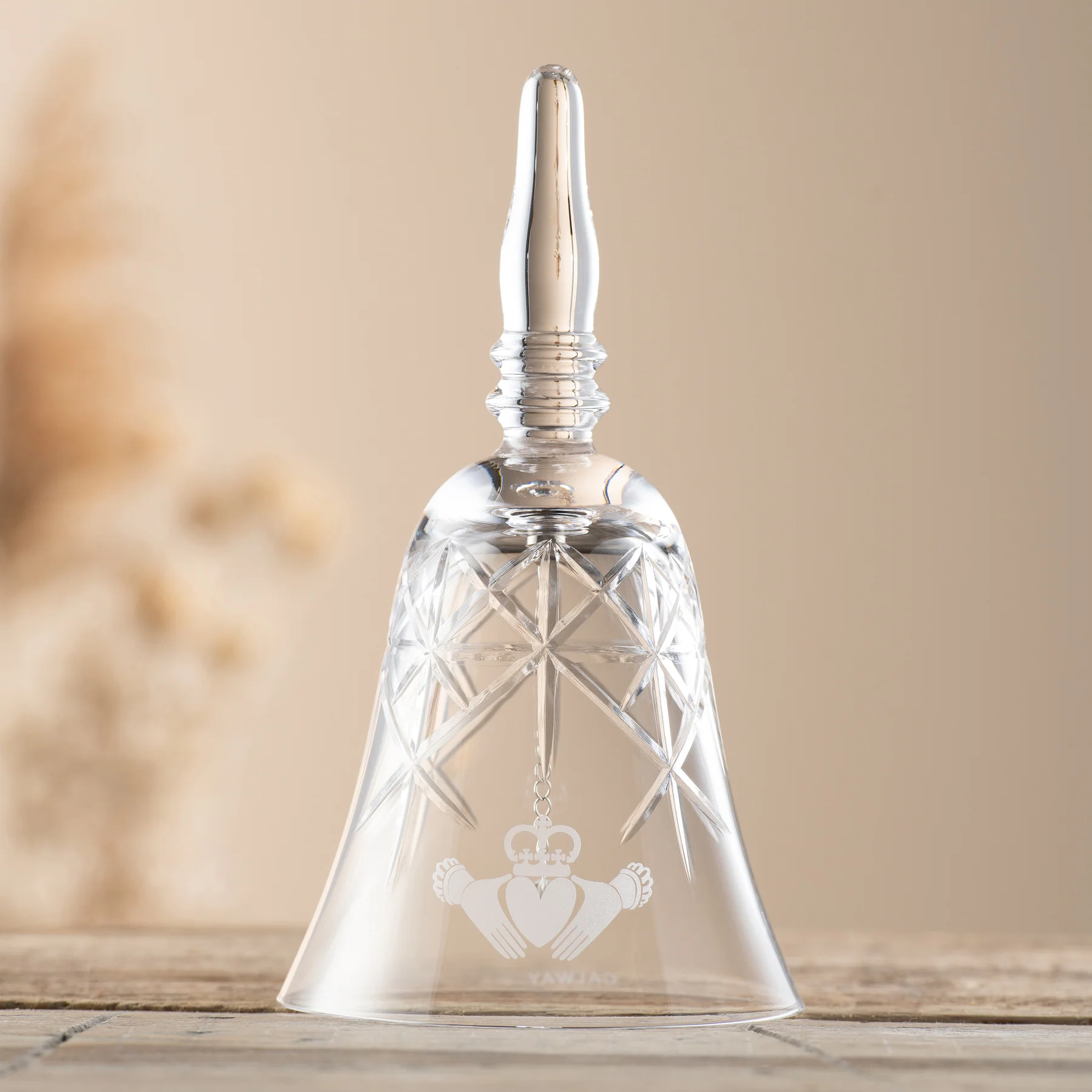 Crystal bell with engraved Claddagh design.