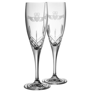 Two engraved crystal champagne flutes.