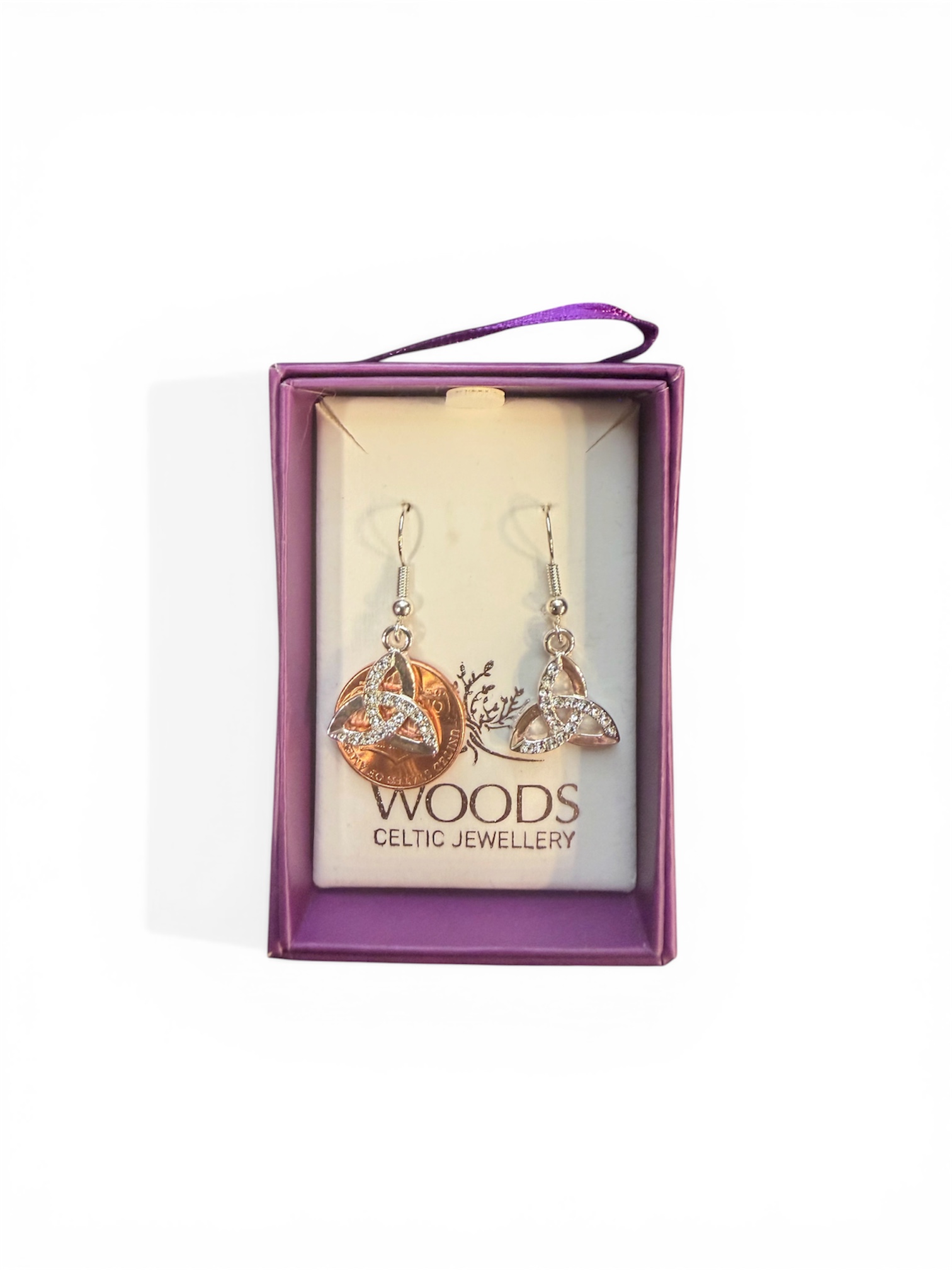 Celtic earrings in a purple jewelry box.
