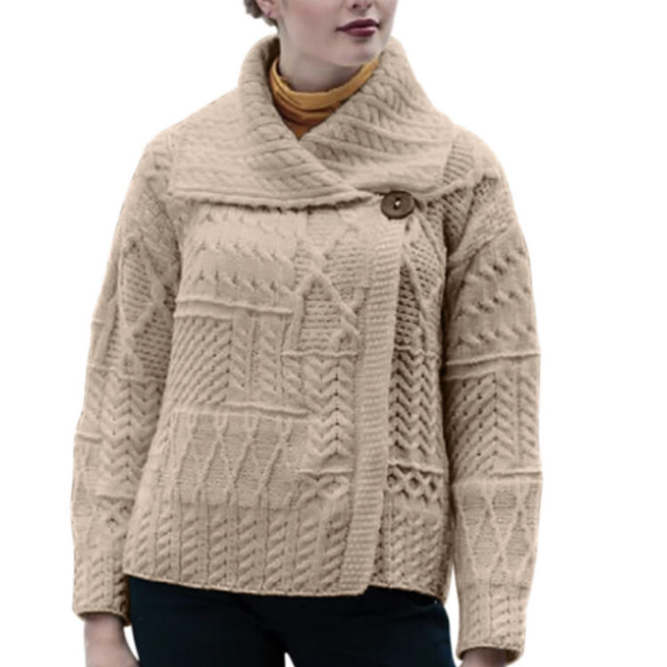 A woman wearing a beige sweater with buttons.
